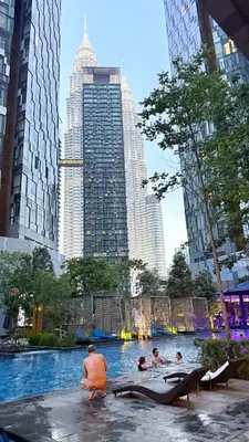 a group of people in a pool in a city at Star Residences Apartment KLCC in Kuala Lumpur