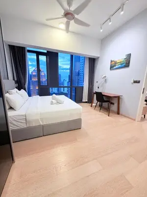 a bedroom with a bed and a desk with a piano at Star Residences Apartment KLCC in Kuala Lumpur