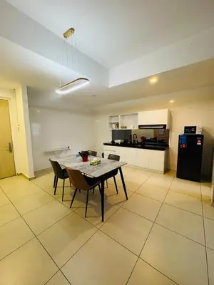 a kitchen and dining room with a table and chairs at Reizz Residence by Ampang Kiri in Kuala Lumpur