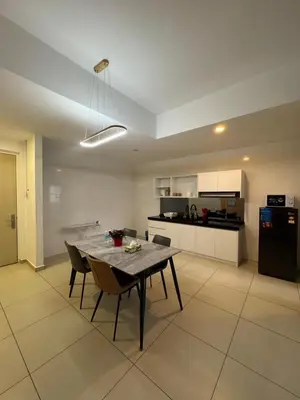 a dining room and kitchen with a table and chairs at Reizz Residence by Ampang Kiri in Kuala Lumpur