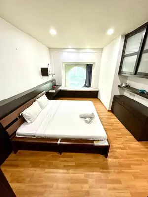 a bedroom with a bed in a room with a window at Vortex suites klcc 8pax with City views in Kuala Lumpur