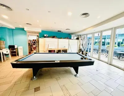 a pool table in a living room with a pool table at Vortex suites klcc 8pax with City views in Kuala Lumpur