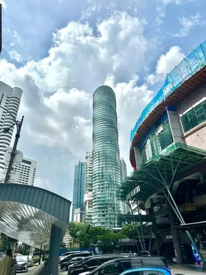 a tall building with cars parked in a city at Vortex suites klcc 8pax with City views in Kuala Lumpur