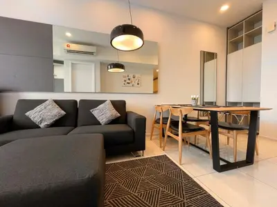 a living room with a couch and a table at The Robertson Bukit Bintang by TALKS COLLECTION in Kuala Lumpur