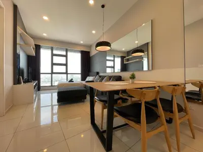a dining room and living room with a table and chairs at The Robertson Bukit Bintang by TALKS COLLECTION in Kuala Lumpur