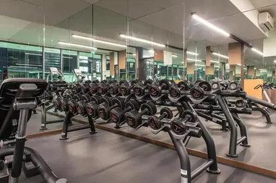 a row of rows of exercise bikes in a gym at The Robertson Bukit Bintang by TALKS COLLECTION in Kuala Lumpur