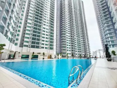 a large swimming pool in front of tall buildings at RC Balqis Homestay in Kuala Lumpur