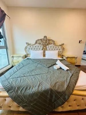 a bedroom with a large bed with a headboard at Regalia Apartments By FA 6 in Kuala Lumpur