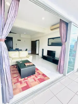 a living room with a couch and a table at Regalia Apartments By FA 6 in Kuala Lumpur