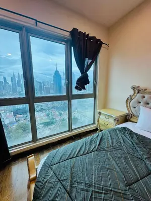 a bedroom with a bed and a large window at Regalia Apartments By FA 6 in Kuala Lumpur
