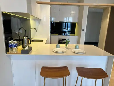 a kitchen with two chairs and a counter with two plates at Astra Suites - Star Residence KL in Kuala Lumpur