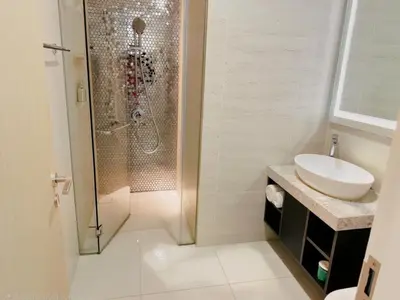 a bathroom with a shower and a sink and a toilet at Astra Suites - Star Residence KL in Kuala Lumpur