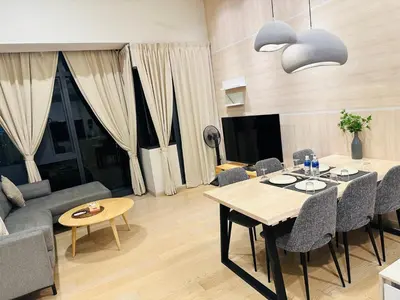 a living room with a table and a couch at Astra Suites - Star Residence KL in Kuala Lumpur