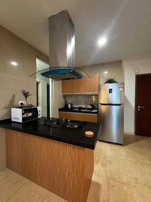 a kitchen with a stainless steel refrigerator and a microwave at Stylish City Hideout - Comfy Sofa, Warm Ambience in Kuala Lumpur