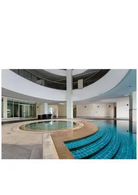 a large pool in a large building with a ceiling at Stylish City Hideout - Comfy Sofa, Warm Ambience in Kuala Lumpur