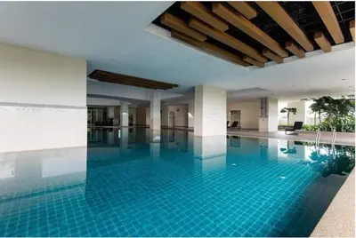 a swimming pool with blue tiles in a building at Stylish City Hideout - Comfy Sofa, Warm Ambience in Kuala Lumpur
