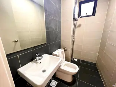a bathroom with a sink and a toilet and a mirror at Tuan Residency in Kuala Lumpur