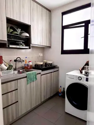 a kitchen with a washing machine and a window at Tuan Residency in Kuala Lumpur