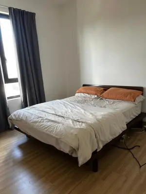 a bed sitting in a bedroom with a window at Tuan Residency in Kuala Lumpur
