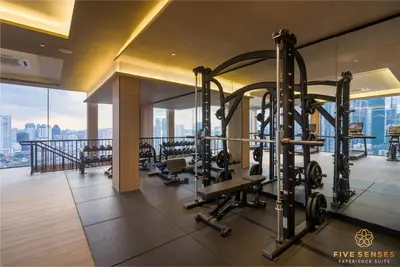 a gym with cardio equipment in a building at Armani Residence Kuala Lumpur in Kuala Lumpur