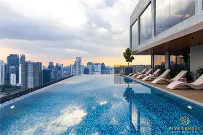 a pool on the roof of a building with a city skyline at Armani Residence Kuala Lumpur in Kuala Lumpur