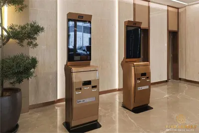two video game machines in a lobby with plants at Armani Residence Kuala Lumpur in Kuala Lumpur