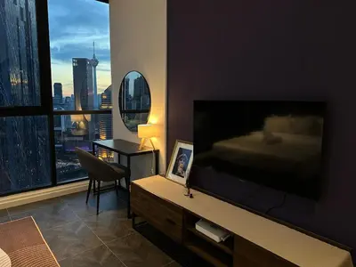 a living room with a large flat screen television at Scarletz Suites KLCC Studio in Kuala Lumpur