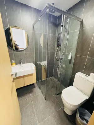 a bathroom with a shower and a toilet and a sink at The Luxe Infinity Skypool By Tasu Homes in Kuala Lumpur