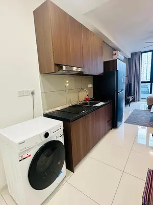 a kitchen with a washing machine in a kitchen at Majestic Residence KLCC By Alfa in Kuala Lumpur