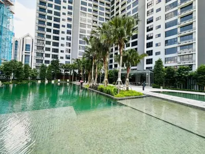a pool of water with palm trees and buildings at Agile Sky Pavilion Homestay Bukit Bintang KL in Kuala Lumpur