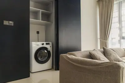 a living room with a washing machine and a couch at Novo Ampang 2 Bedrooms KLCC view in Kuala Lumpur