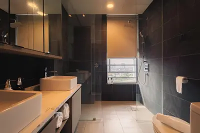 a bathroom with two sinks and a shower at Novo Ampang 2 Bedrooms KLCC view in Kuala Lumpur
