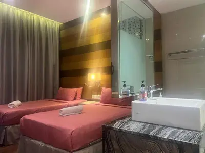 a bathroom with two beds and a sink and a mirror at D Majestic hosted by Super Tang in Kuala Lumpur