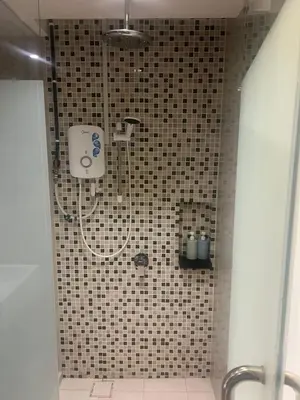 a shower in a bathroom with a tiled wall at D Majestic hosted by Super Tang in Kuala Lumpur
