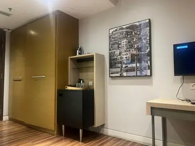 a room with a door and a desk and a television at D Majestic hosted by Super Tang in Kuala Lumpur