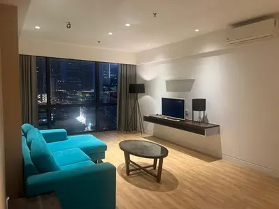 a living room with a blue couch and a television at D Majestic hosted by Super kk in Kuala Lumpur