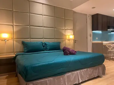 a bedroom with a large bed with blue pillows at D Majestic hosted by Super kk in Kuala Lumpur
