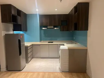 a kitchen with wooden cabinets and a refrigerator at D Majestic hosted by Super kk in Kuala Lumpur