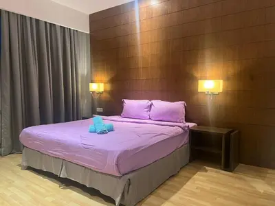 a bedroom with a bed with purple sheets and pink pillows at D Majestic hosted by Super kk in Kuala Lumpur