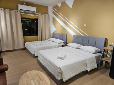 two beds in a hotel room with two rings on them at CEMPAKA SUITES By VG Homes in Kuala Lumpur