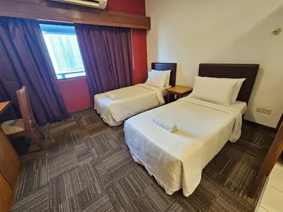 a hotel room with two beds and a window at CEMPAKA SUITES By VG Homes in Kuala Lumpur