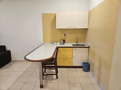 a small kitchen with a table and a sink at CEMPAKA SUITES By VG Homes in Kuala Lumpur