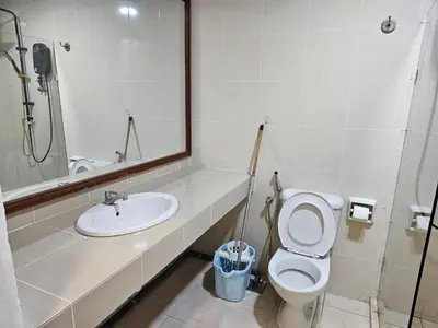 a bathroom with a sink and a toilet and a mirror at CEMPAKA SUITES By VG Homes in Kuala Lumpur