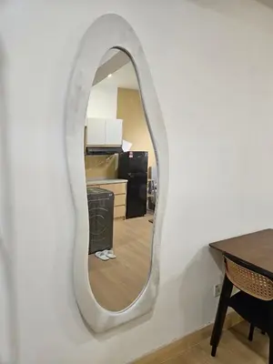 a mirror on a wall in a living room at CEMPAKA SUITES By VG Homes in Kuala Lumpur