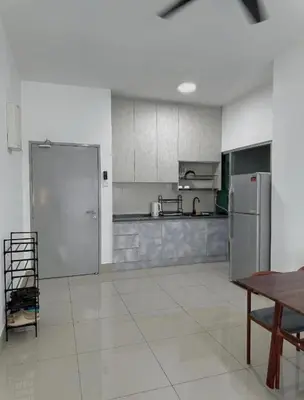 a large kitchen with stainless steel appliances and a table at ESU Home Ventures in Kuala Lumpur