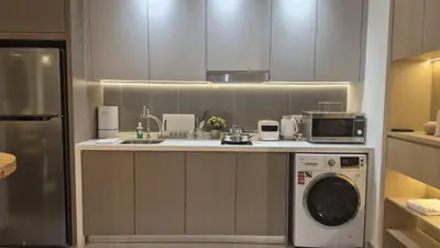 a kitchen with a washing machine and a microwave at Nature Home Agile Bukit Bintang TRX Pavillion Nice View Free Netflix #3 in Kuala Lumpur