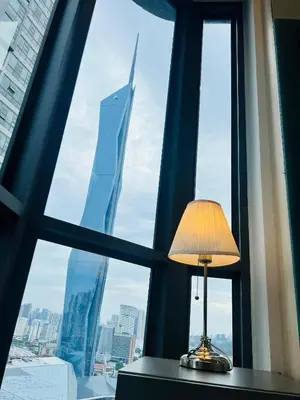 a lamp sitting on a table in front of a window at Trion Dream house KL City in Kuala Lumpur