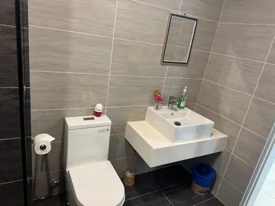 a bathroom with a white toilet and a sink at Trion Dream house KL City in Kuala Lumpur