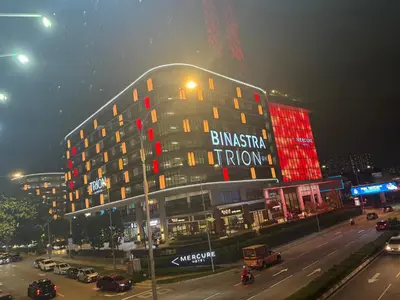 a building with red lights on the side of a street at Trion Dream house KL City in Kuala Lumpur