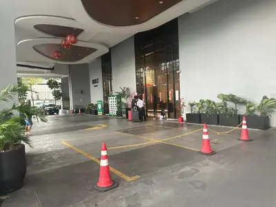 a parking lot with orange cones in front of a building at Trion Dream house KL City in Kuala Lumpur